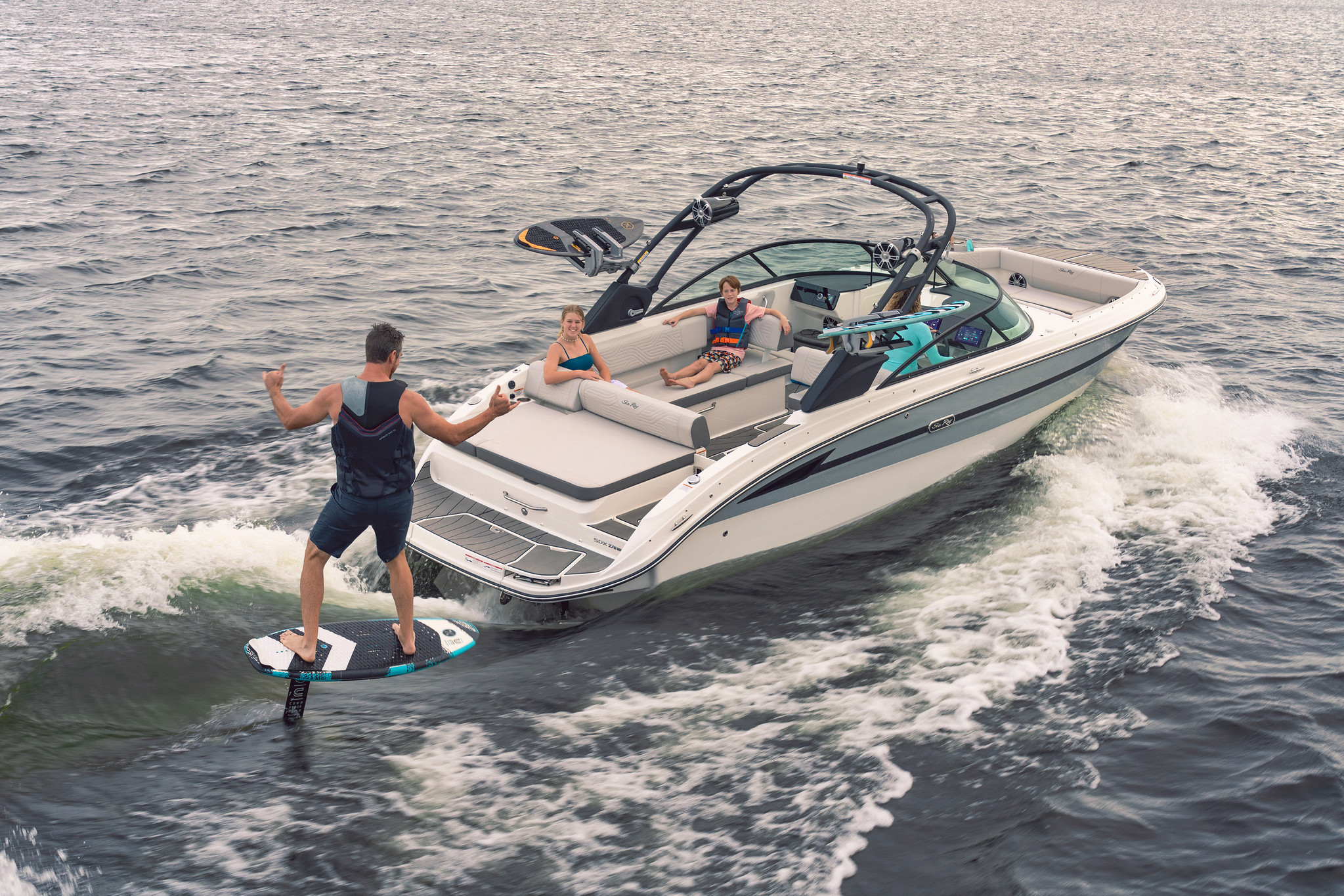 Man foilboarding behind an SDX 270 Surf