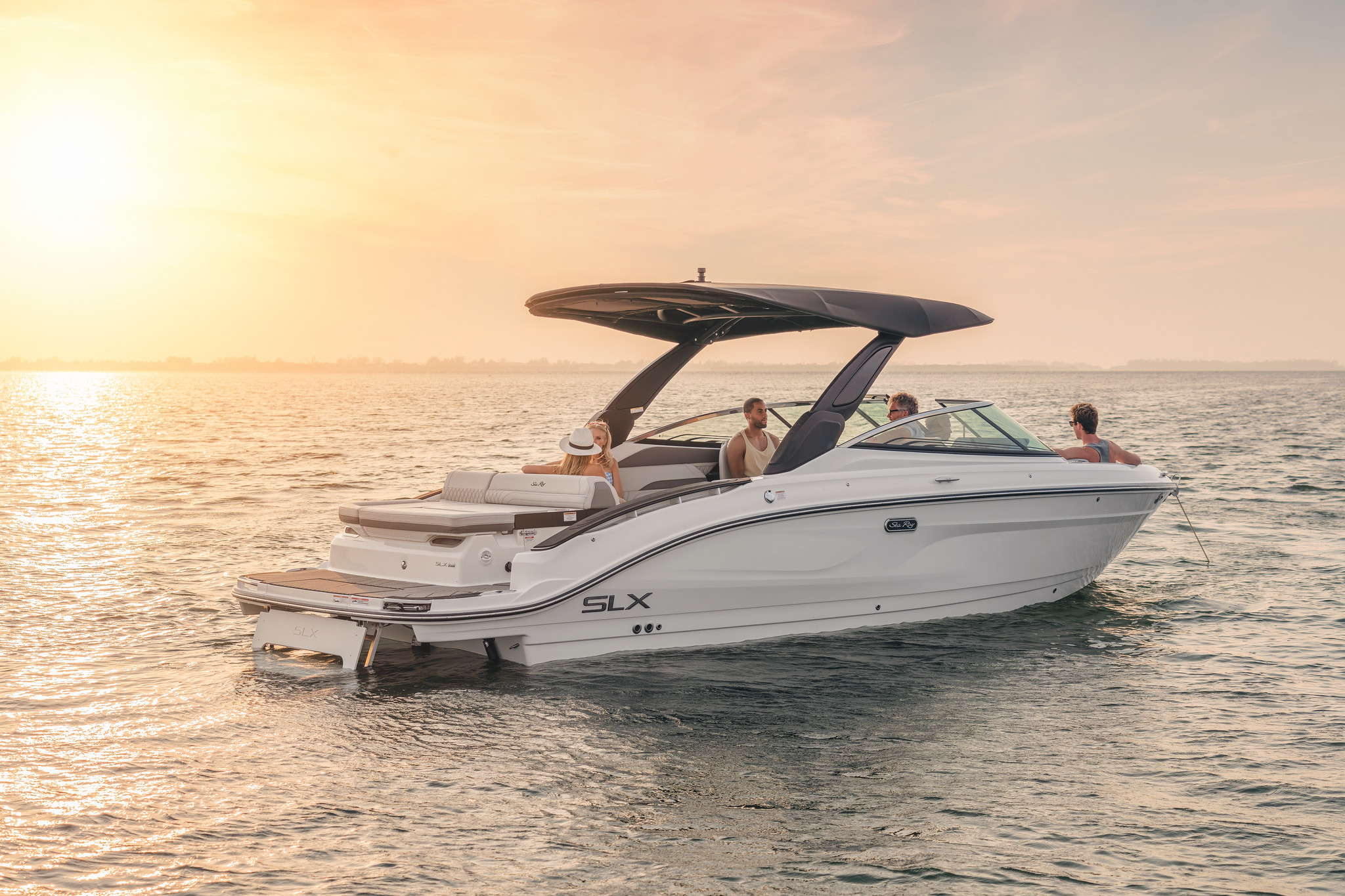 Friends aboard an SLX 280 at sunset